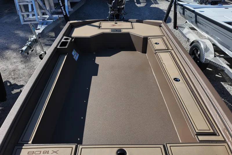 Slide: The Image of 2026 Xpress X18DB boat interior with storage compartments and cup holders. - 10