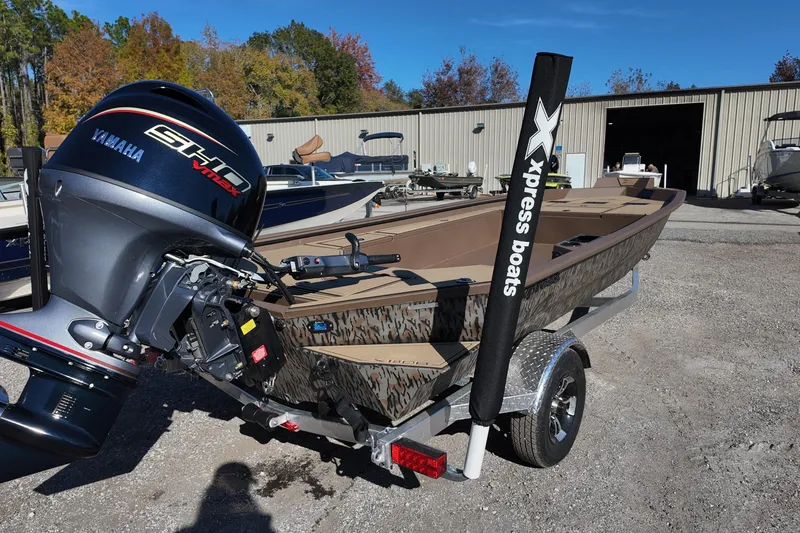 Slide: The Image of 2026 Xpress X18DB boat with Yamaha engine on trailer, outdoors. - 3