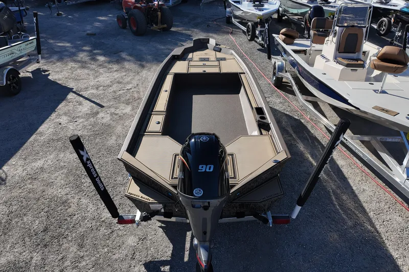 Slide: The Image of 2026 Xpress X18DB boat with 90HP engine, displayed outdoors among other boats. - 5