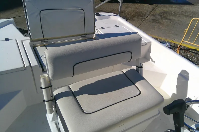 Slide: The Image of 2017 Outcast 19V boat interior with cushioned seating and storage compartment. - 10