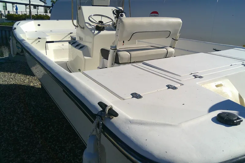 Slide: The Image of 2017 Outcast 19V boat with white interior and steering console. - 11