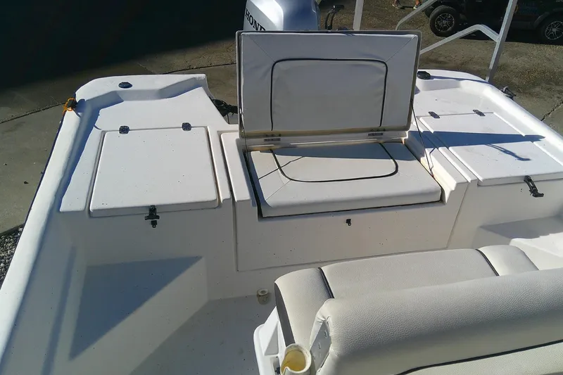Slide: The Image of 2017 Outcast 19V boat interior with open storage compartments and seating. - 14