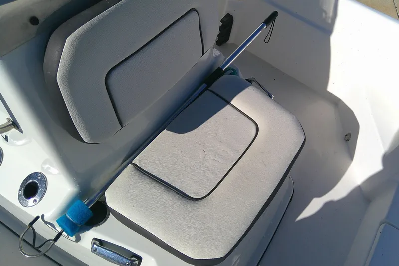 Slide: The Image of Boat interior with cushioned seating, featuring Outcast 19V model, 2017. - 16