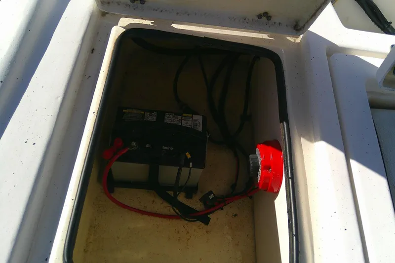 Slide: The Image of Battery compartment of 2017 Outcast 19V boat with visible wiring and connections. - 18