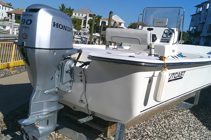 Slide: The Image of 2017 Outcast 19V boat with Honda 90 VTEC outboard motor docked in marina. - 2