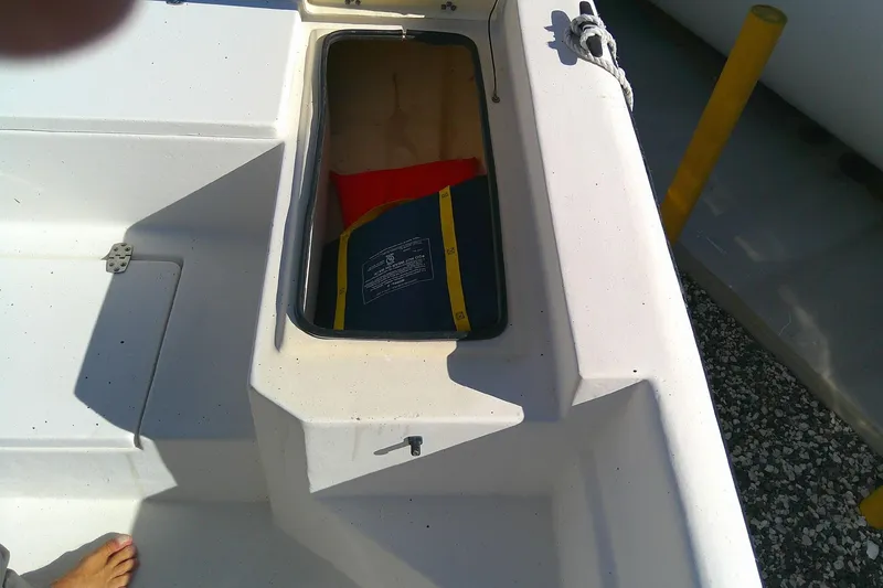 Slide: The Image of Open storage compartment on 2017 Outcast 19V boat with life jacket inside. - 20