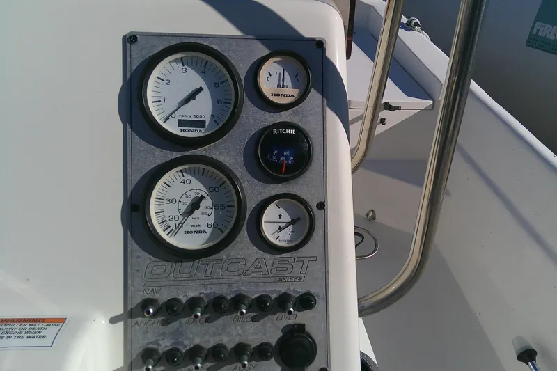 Slide: The Image of Instrument panel of 2017 Outcast 19V boat with Honda gauges and Ritchie compass. - 21