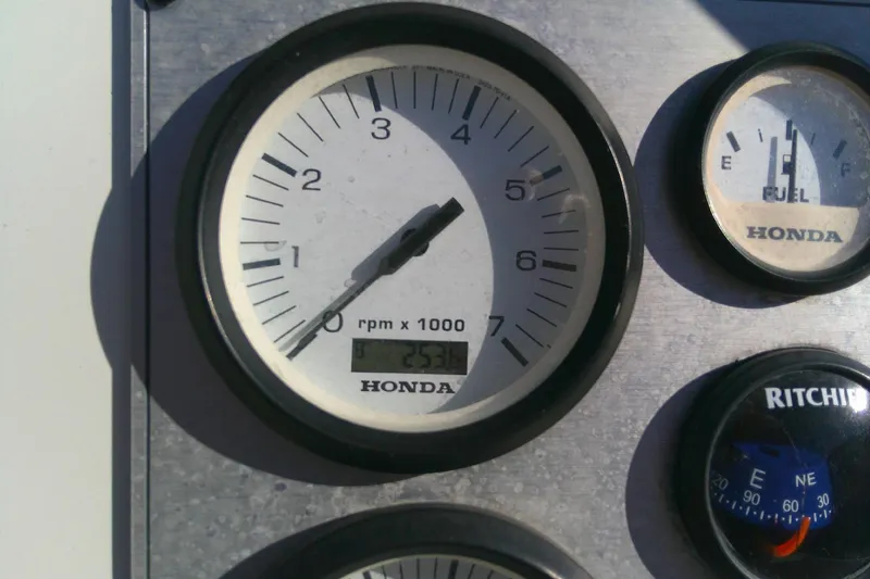 Slide: The Image of Close-up of Honda tachometer and fuel gauge on 2017 Outcast 19V boat dashboard. - 22