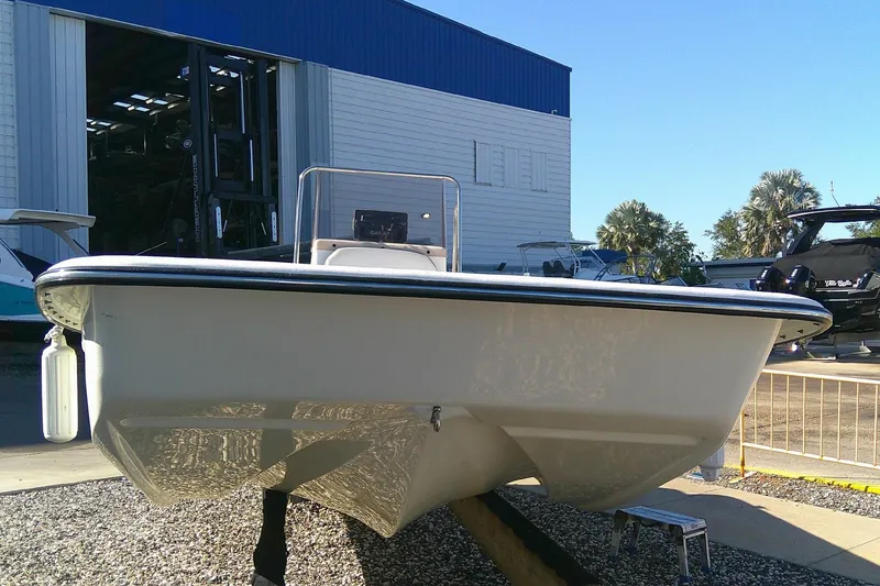 Slide: The Image of 2017 Outcast 19V boat displayed outdoors near a storage facility. - 4