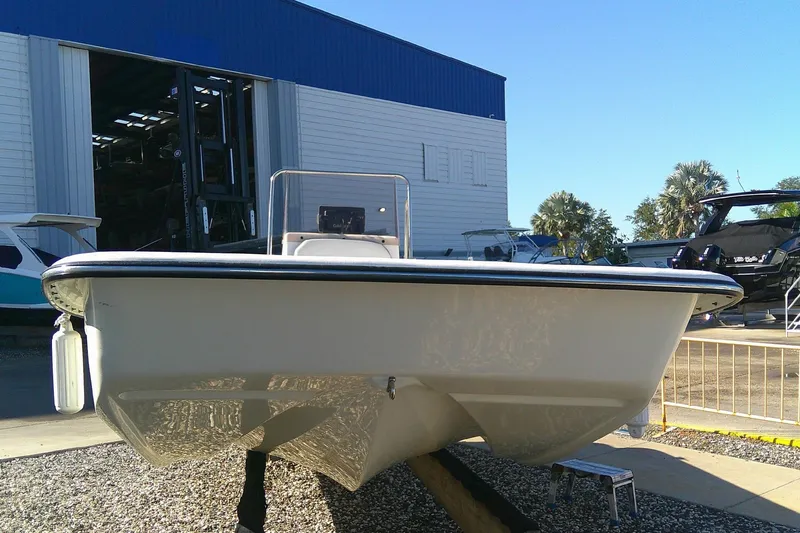 Slide: The Image of 2017 Outcast 19V boat displayed at a marina with other vessels. - 9