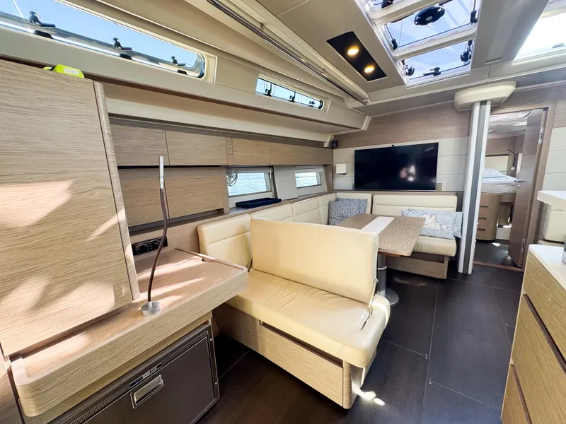 Slide: The Image of Luxurious 2019 Hanse 588 yacht interior with modern seating and large windows. - 10