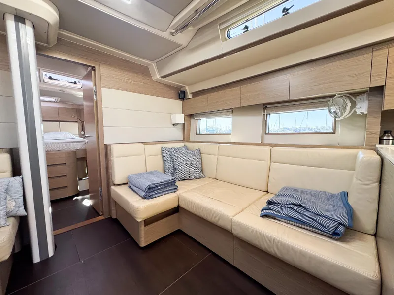 Slide: The Image of Luxurious interior of 2019 Hanse 588 yacht with beige seating and cozy decor. - 14