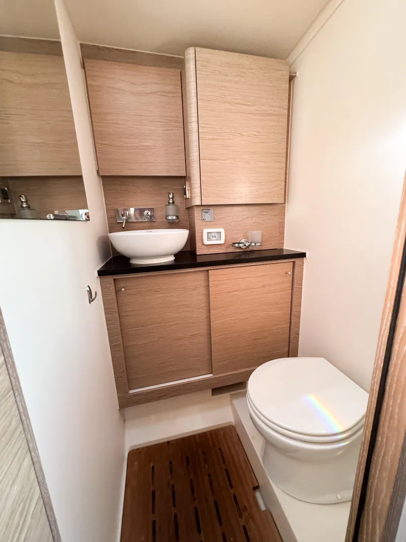 Slide: The Image of Modern bathroom in 2019 Hanse 588 yacht with wooden cabinetry and sleek fixtures. - 16
