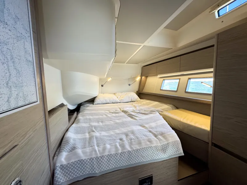Slide: The Image of Luxurious cabin interior of 2019 Hanse 588 yacht with cozy bed and ocean view. - 17