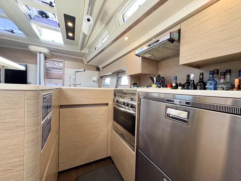 Slide: The Image of Modern kitchen interior of 2019 Hanse 588 yacht with appliances and wooden cabinetry. - 19