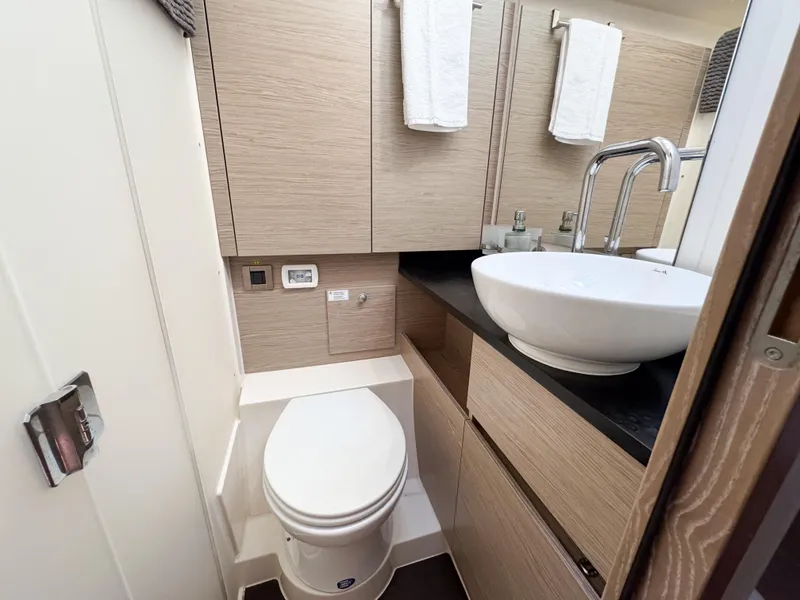 Slide: The Image of Modern bathroom in 2019 Hanse 588 yacht with sleek fixtures and wood cabinetry. - 21