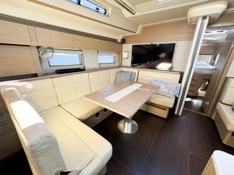 Slide: The Image of Luxurious interior of 2019 Hanse 588 yacht with modern seating and dining area. - 9