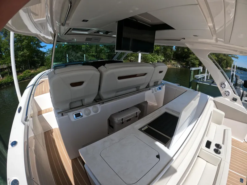 Slide: The Image of 2024 Tiara Yachts 43 LS interior with seating, TV, and sleek design. - 14