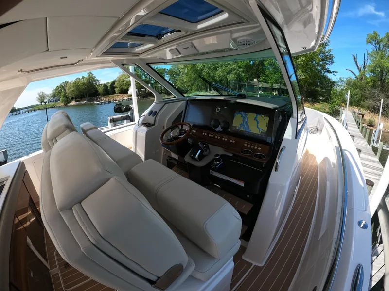 Slide: The Image of 2024 Tiara Yachts 43 LS cockpit with luxurious seating and advanced navigation system. - 17