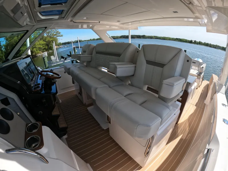 Slide: The Image of 2024 Tiara Yachts 43 LS interior with luxurious seating and scenic water view. - 19