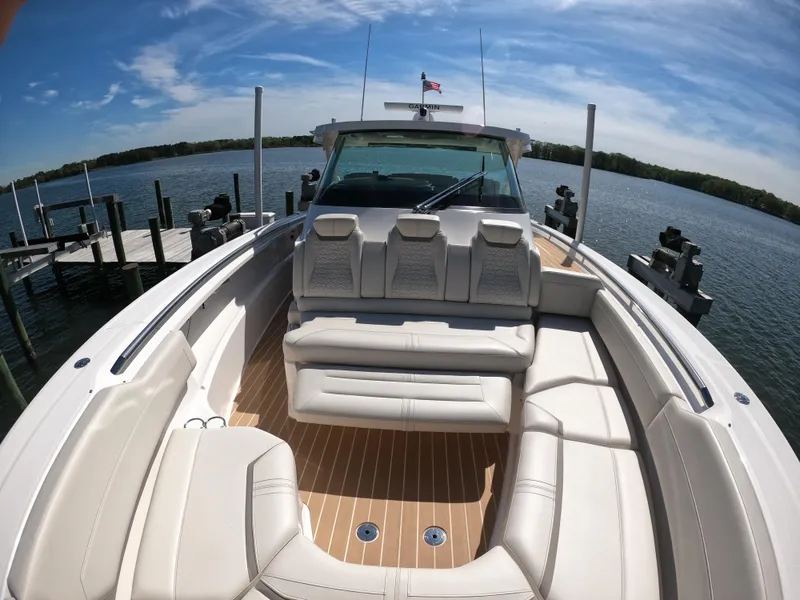 Slide: The Image of 2024 Tiara Yachts 43 LS luxury boat with spacious seating on a sunny day. - 23