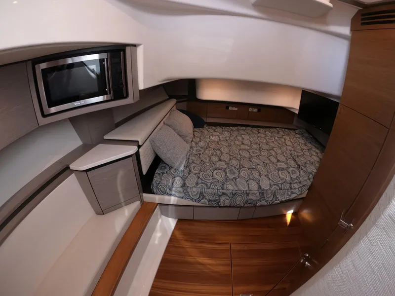 Slide: The Image of 2024 Tiara Yachts 43 LS cabin interior with bed and modern amenities. - 24