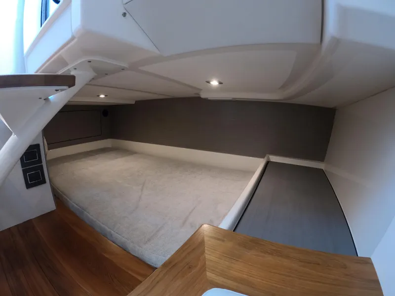 Slide: The Image of 2024 Tiara Yachts 43 LS cabin interior with modern design and cozy sleeping area. - 26