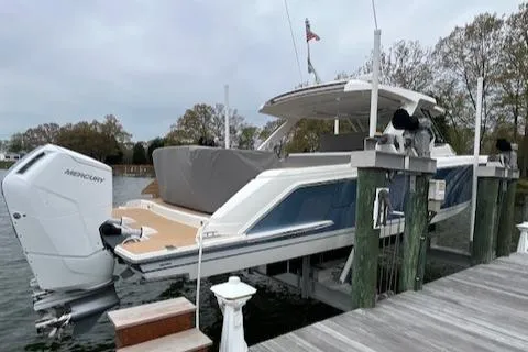 Slide: The Image of 2024 Tiara Yachts 43 LS docked, featuring sleek design and powerful Mercury outboard engine. - 8