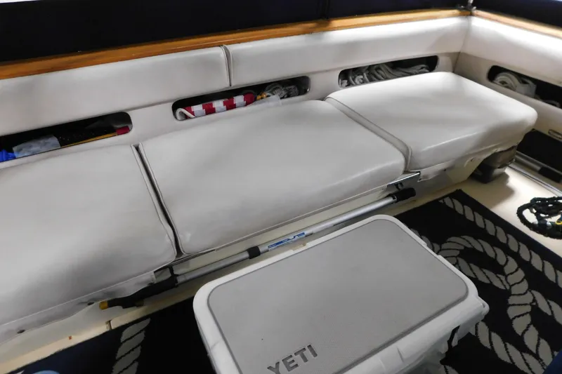 Slide: The Image of Interior seating of 1986 Sea Ray 390 Express Cruiser with storage compartments and Yeti cooler. - 10
