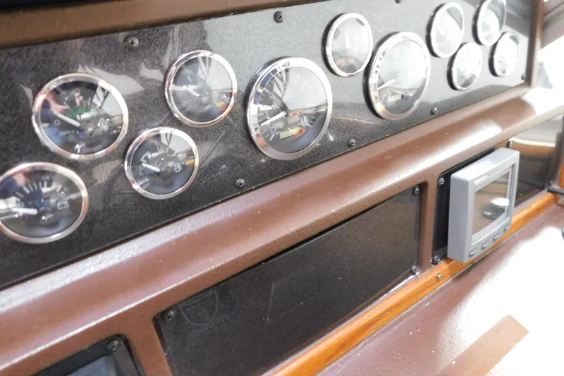 Slide: The Image of 1986 Sea Ray 390 Express Cruiser dashboard with gauges and electronic display. - 14