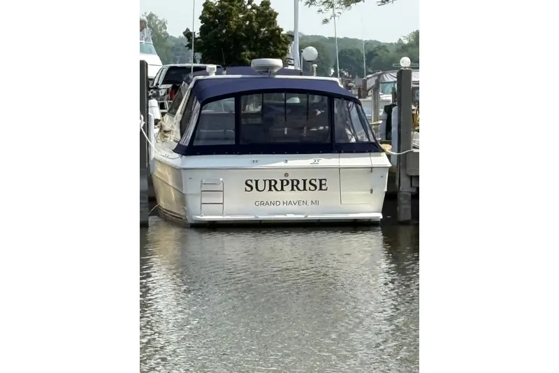 Slide: The Image of 1986 Sea Ray 390 Express Cruiser docked, named "Surprise," in Grand Haven, MI. - 2