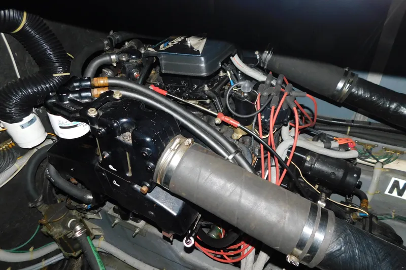 Slide: The Image of Engine compartment of a 1986 Sea Ray 390 Express Cruiser with visible hoses and wiring. - 31