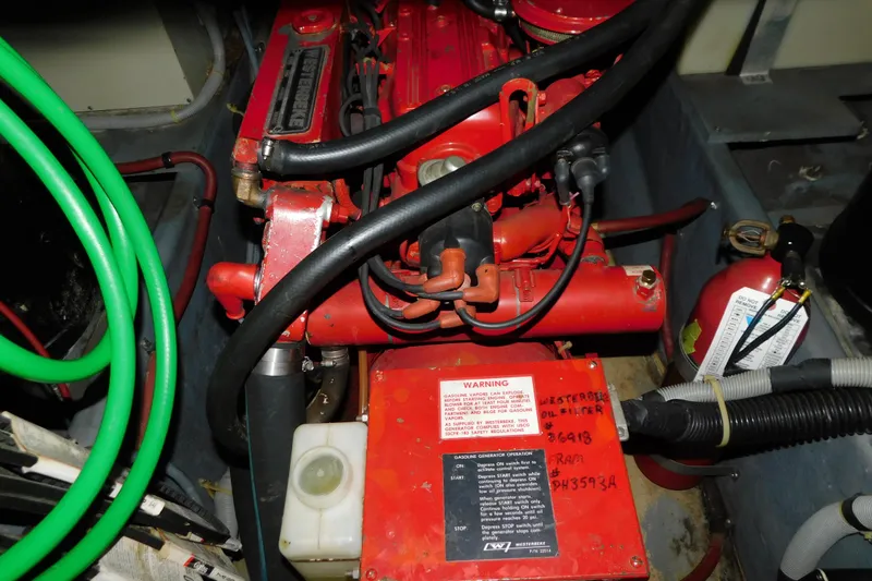 Slide: The Image of Engine compartment of 1986 Sea Ray 390 Express Cruiser with red engine components. - 34
