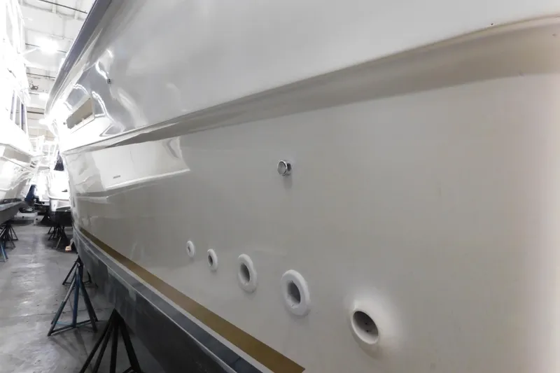 Slide: The Image of 1986 Sea Ray 390 Express Cruiser in storage, side view of hull and portholes. - 4