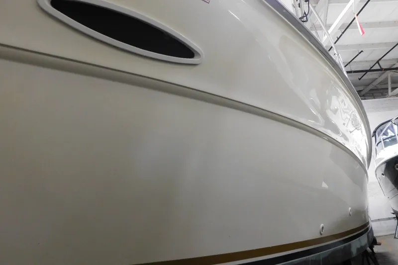 Slide: The Image of 1986 Sea Ray 390 Express Cruiser in storage, showcasing sleek hull design. - 5