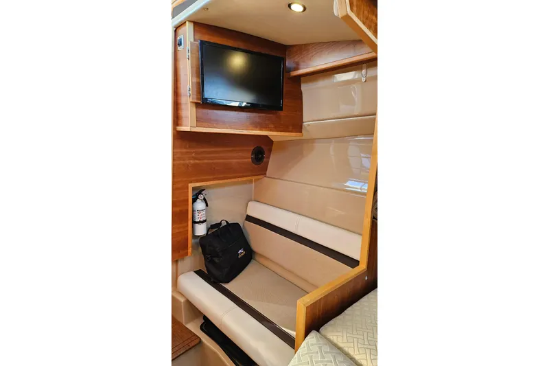 Slide: The Image of Interior of 2016 Cutwater C-28 LE boat with seating, TV, and fire extinguisher. - 16