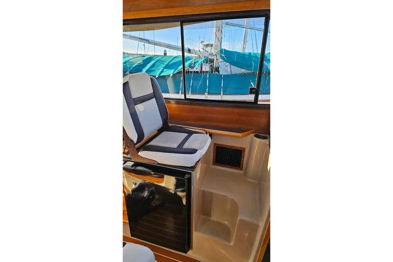 Slide: The Image of 2016 Cutwater C-28 LE interior with cushioned seat and window view. - 20