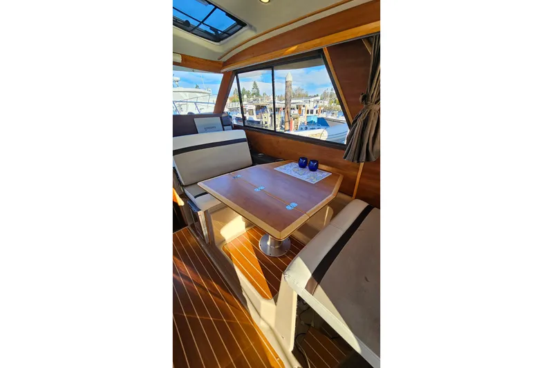 Slide: The Image of Interior of 2016 Cutwater C-28 LE boat with wooden table and seating. - 22