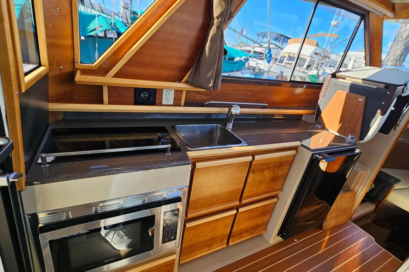 Slide: The Image of Interior view of the kitchen on a 2016 Cutwater C-28 LE boat. - 25