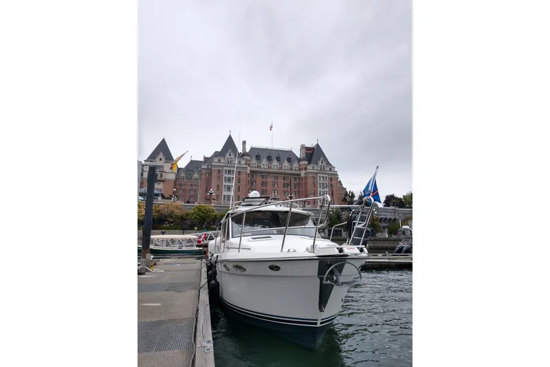 Slide: The Image of 2016 Cutwater C-28 LE boat docked near historic building under cloudy sky. - 5