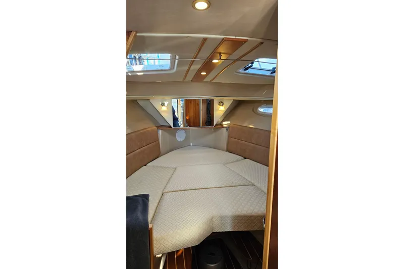 Slide: The Image of 2016 Cutwater C-28 LE cabin interior with cozy bed and elegant lighting. - 9