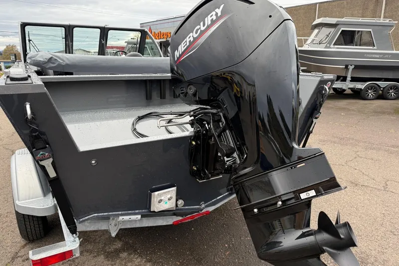 Slide: The Image of 2026 Fish Rite Sportsman 20 boat with Mercury outboard motor, parked on a trailer. - 11