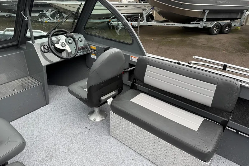 Slide: The Image of 2026 Fish Rite Sportsman 20 boat interior with steering wheel and seating. - 16