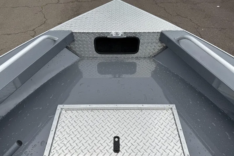 Slide: The Image of 2026 Fish Rite Sportsman 20 boat deck with diamond plate flooring and storage compartment. - 22