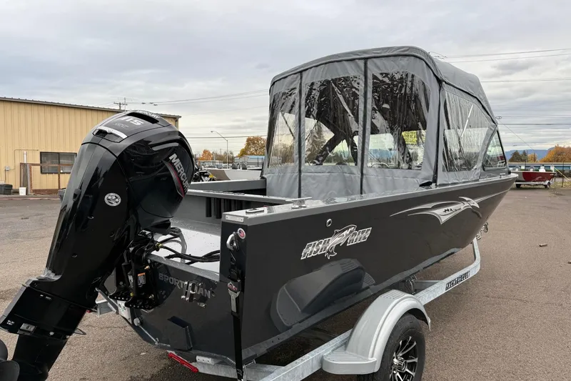 Slide: The Image of 2026 Fish Rite Sportsman 20 boat with Mercury outboard motor, parked on a trailer. - 3