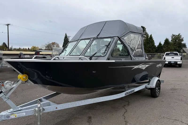 Slide: The Image of 2026 Fish Rite Sportsman 20 boat on trailer, parked outdoors. - 6