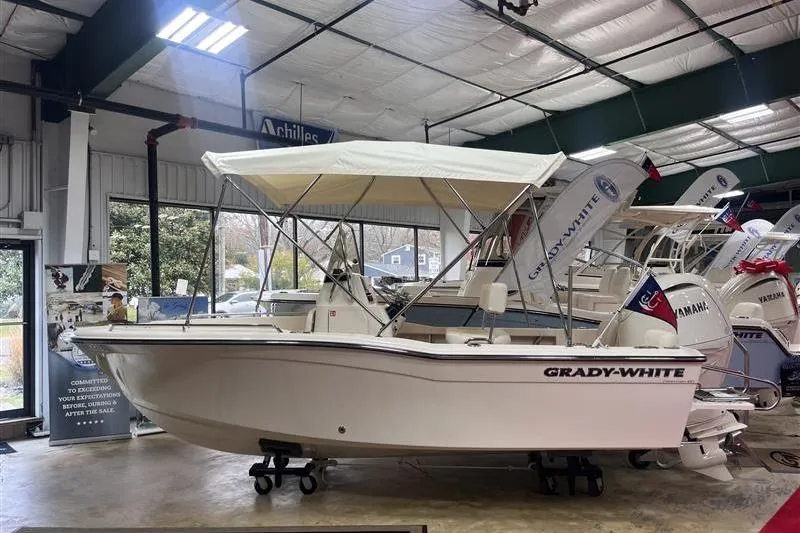 The Image of 2026 Grady-White Fisherman 180 boat displayed in a showroom with canopy. - 0