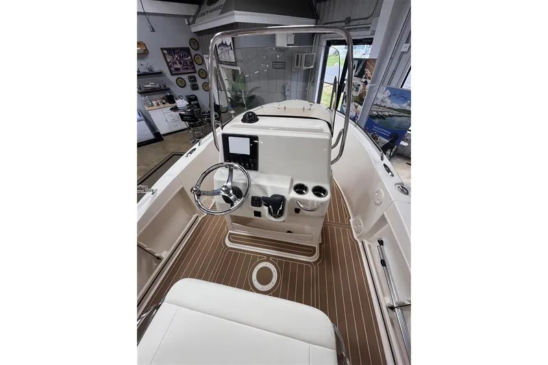 Slide: The Image of 2026 Grady-White Fisherman 180 boat interior with steering wheel and control panel. - 10