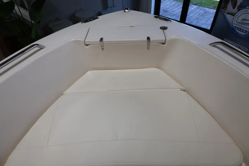 Slide: The Image of 2026 Grady-White Fisherman 180 boat displayed in a showroom with canopy. - 3