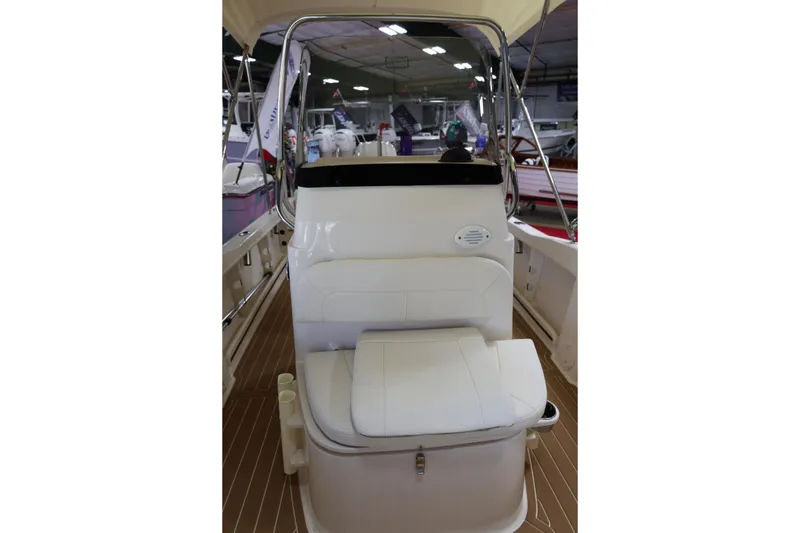 Slide: The Image of 2026 Grady-White Fisherman 180 boat with outboard motor in showroom. - 4